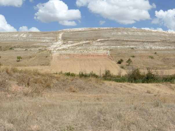 The Meseta is a semi arid land. Wter is scarce. Here farmers have reshaped the slopes of the grassland so as to capture every drop of water. Huge cuts in sidehills show up everywhere
