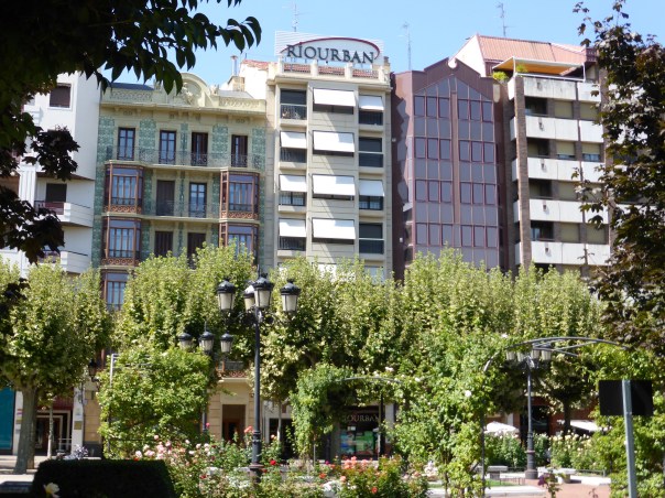 Looking across a beautiful park towards the tall 5 and 6 story renovated apartment buildings, most a few hundred years old