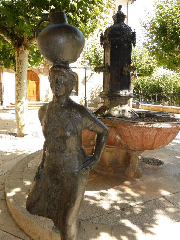 A statue in the town square - that's a wine container on the bronzed statue