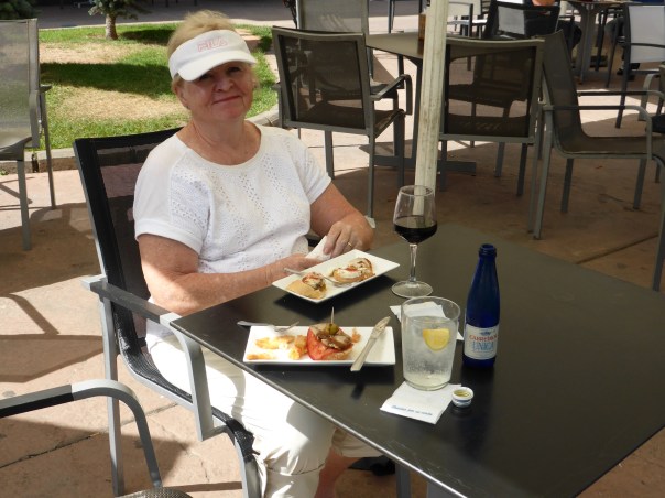 A happy pilgrim having a snack in the afternoon sun after a hot day