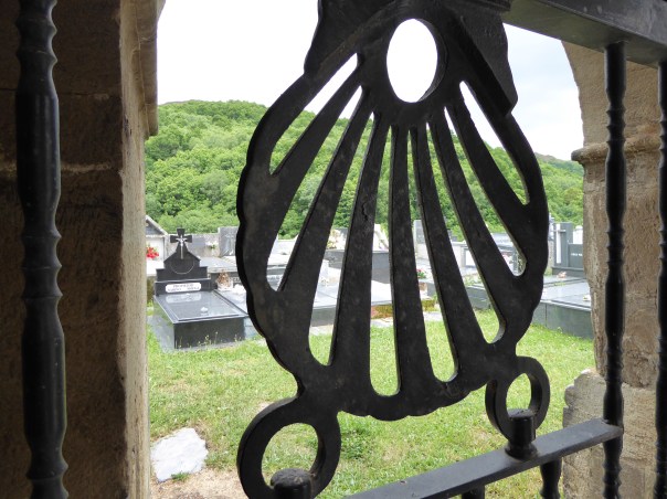 The iron scallop shell symbol of the Camino in the gate of the old church where we later attended evening mass. 