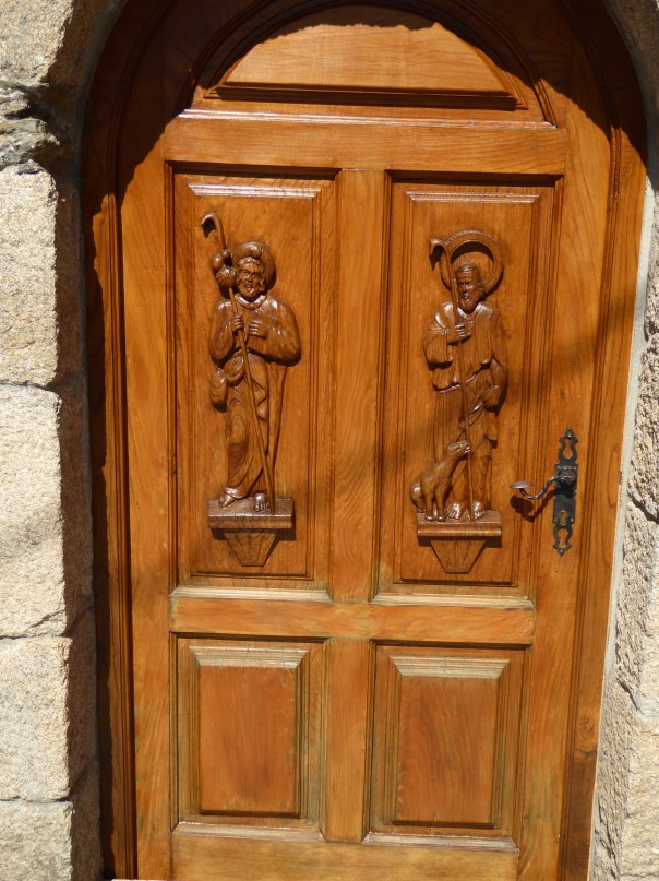 Beautifully carved doors, a common sight.  Between the handsome doors and the always present flower box display, even the time washed apartment can be so welcoming.