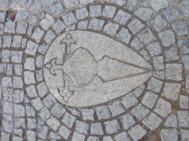 The Camino trail is marked in many ways, the most usual being the shell in either metal or plaster / cement or simply a yellow arrow to indicate the way. Here the Templar influence incorporating the shell with the sword.