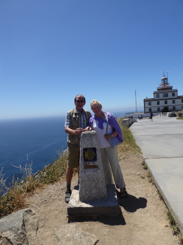 Here we are, leaving our stones . that we have carried throught the length of the Camino, at mile zero at the Finistere lighthouse.  Zoom in on our hands and you will see the stones. 